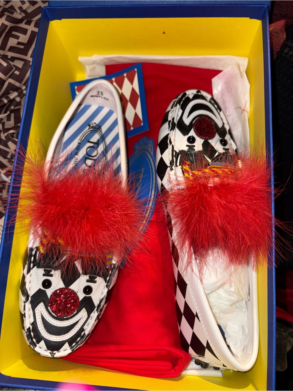 Tod's White and Black Harlequin Loafers with Red Feather Accent